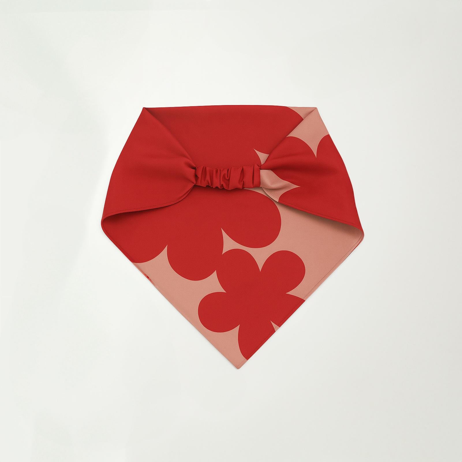 Red and blush pink headband bandana with oversized floral patterns and a gathered elastic detail at the back, displayed flat on a white background.