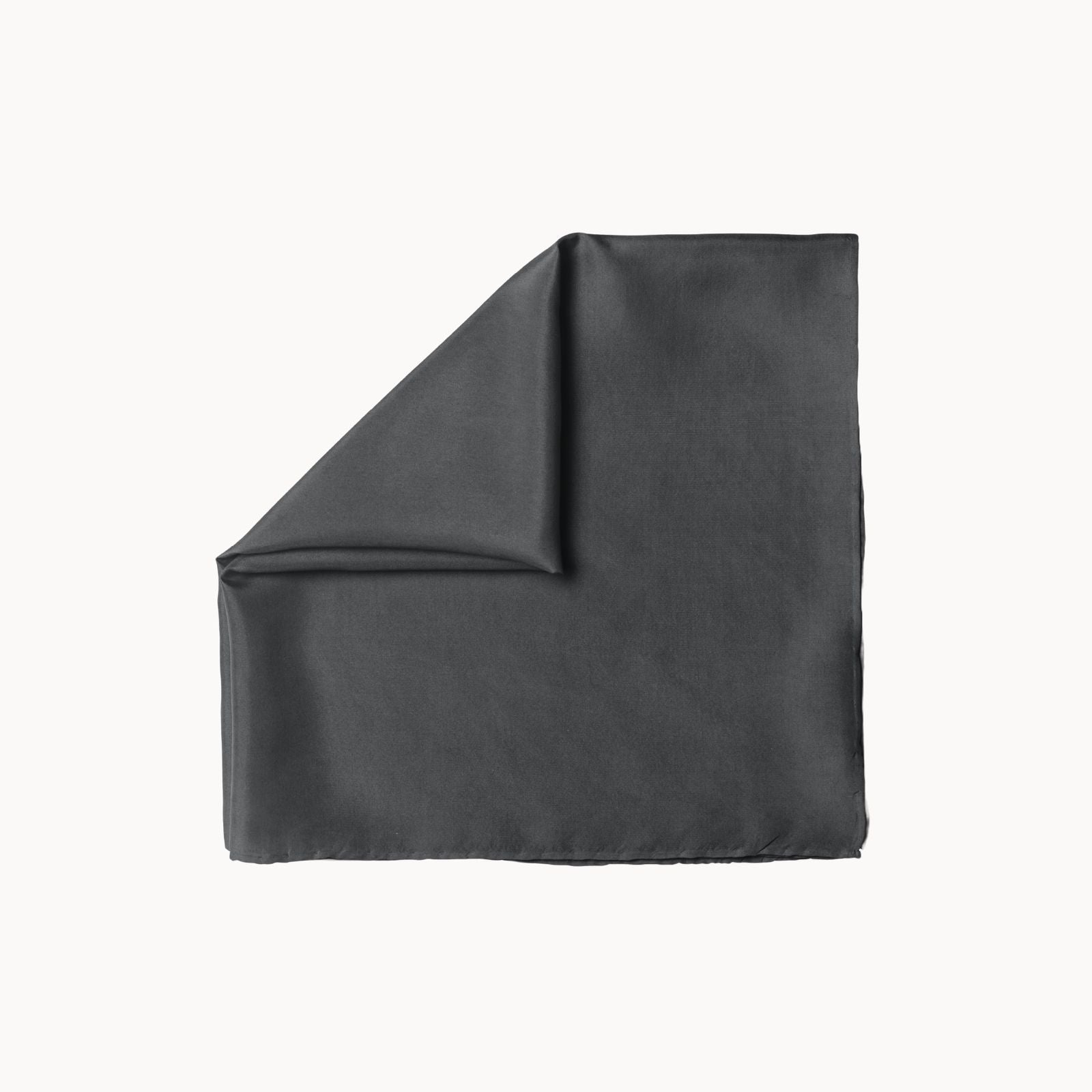 Folded graphite grey solid headscarf on a light background