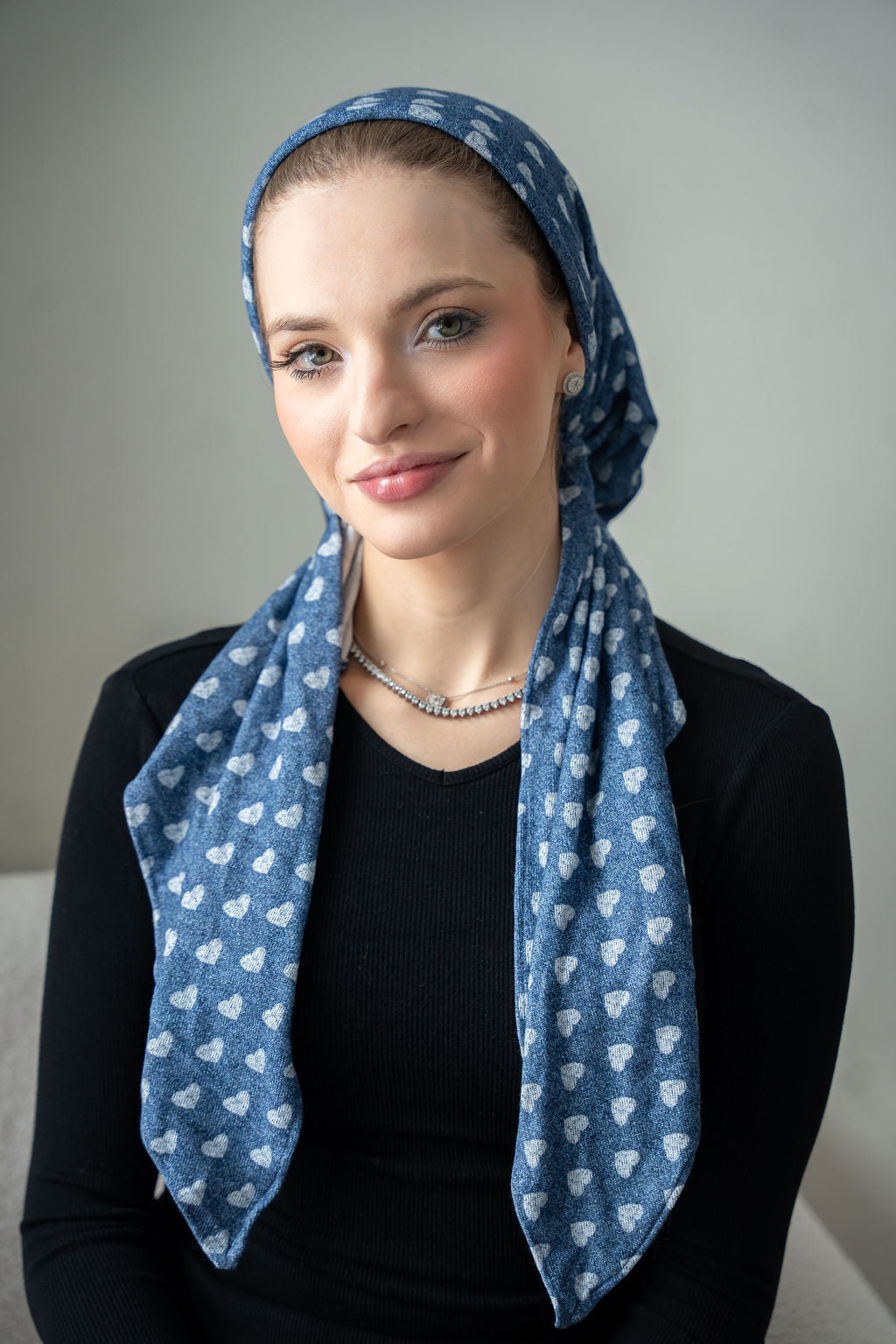 Crafted from soft, faded denim and adorned with a delicate heart print.