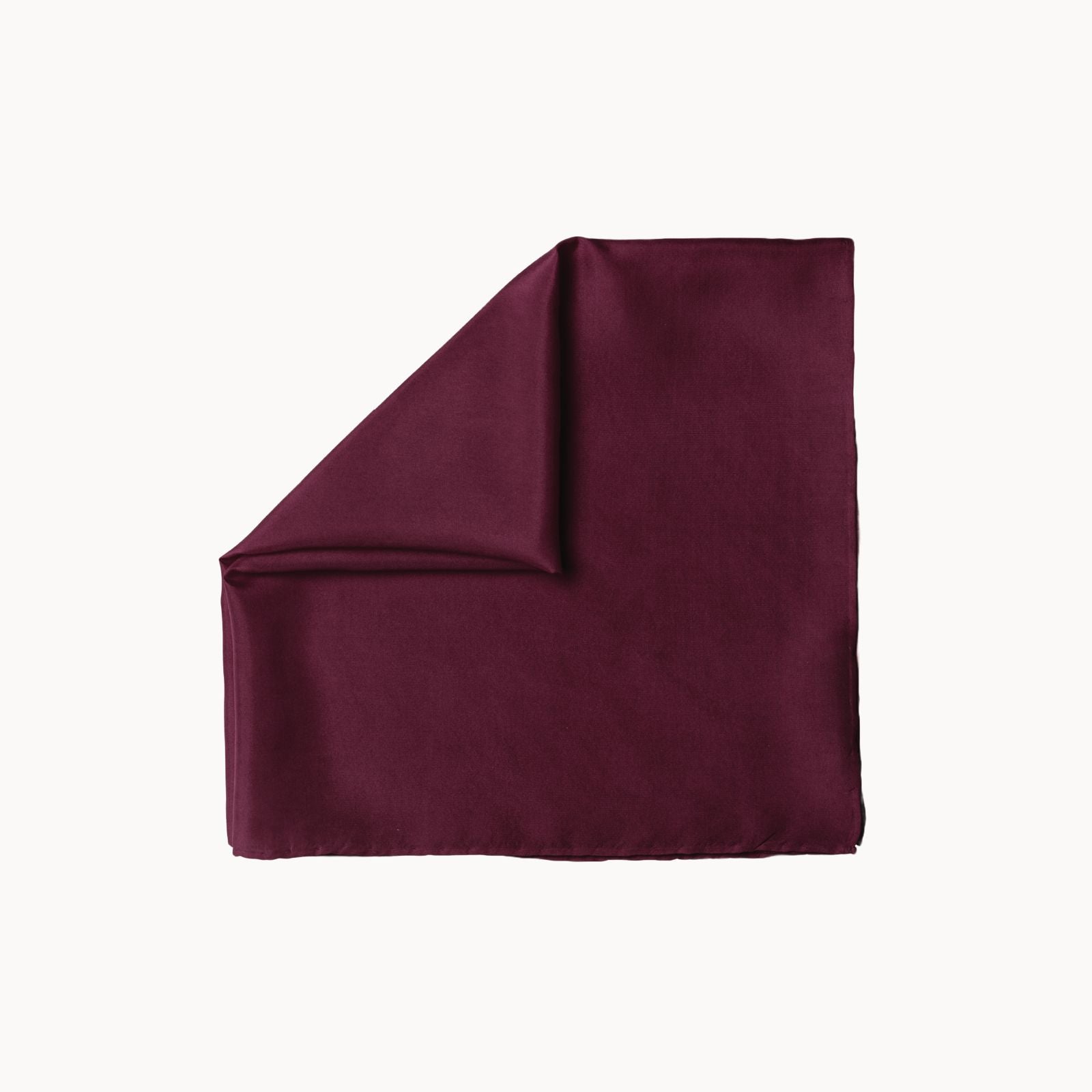Folded square silk headscarf in a deep merlot wine hue, featuring a rich, smooth surface with a luxurious satin sheen, neatly displayed on a white background.