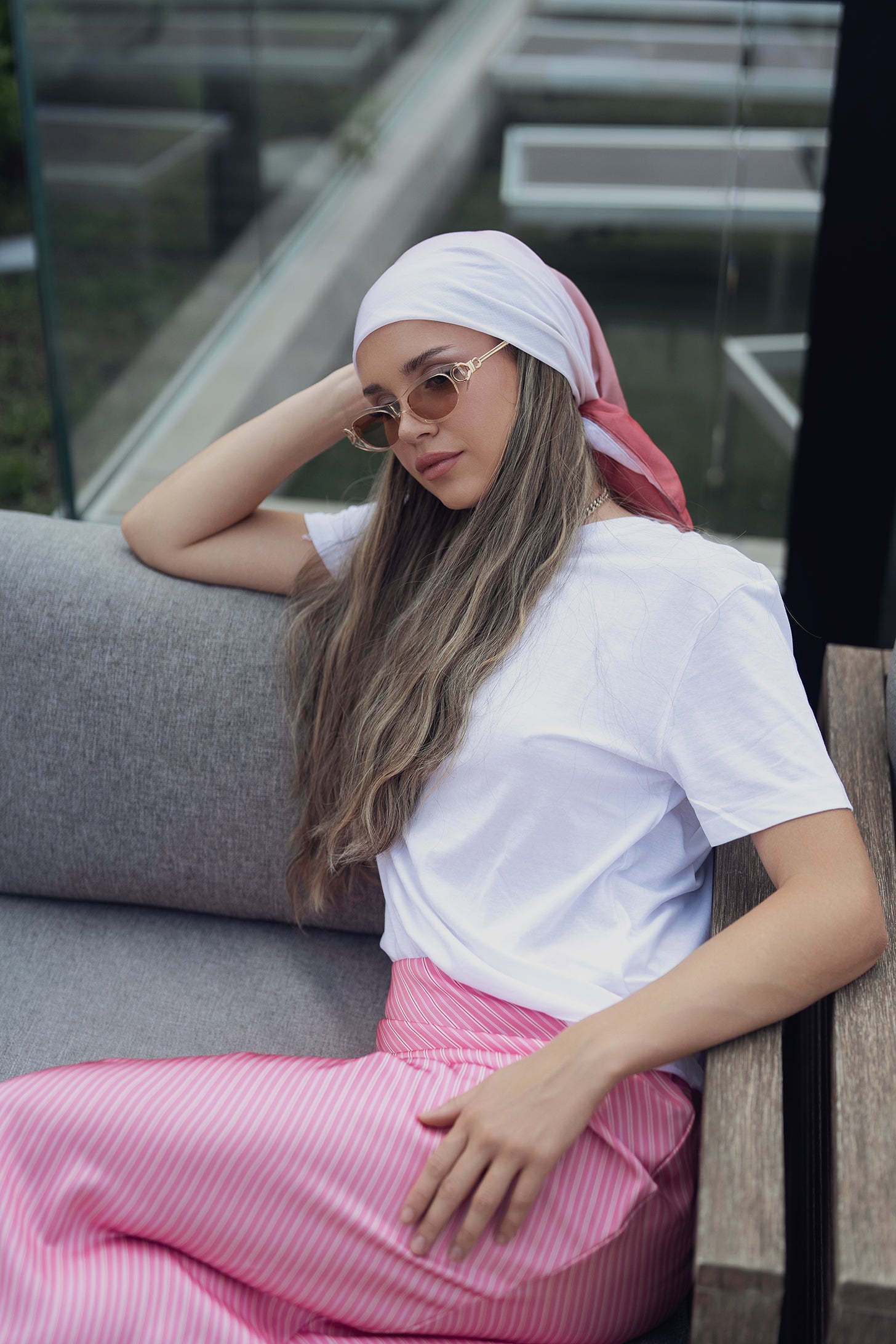 Pale pink headscarf styled with gold necklace and white shirt
