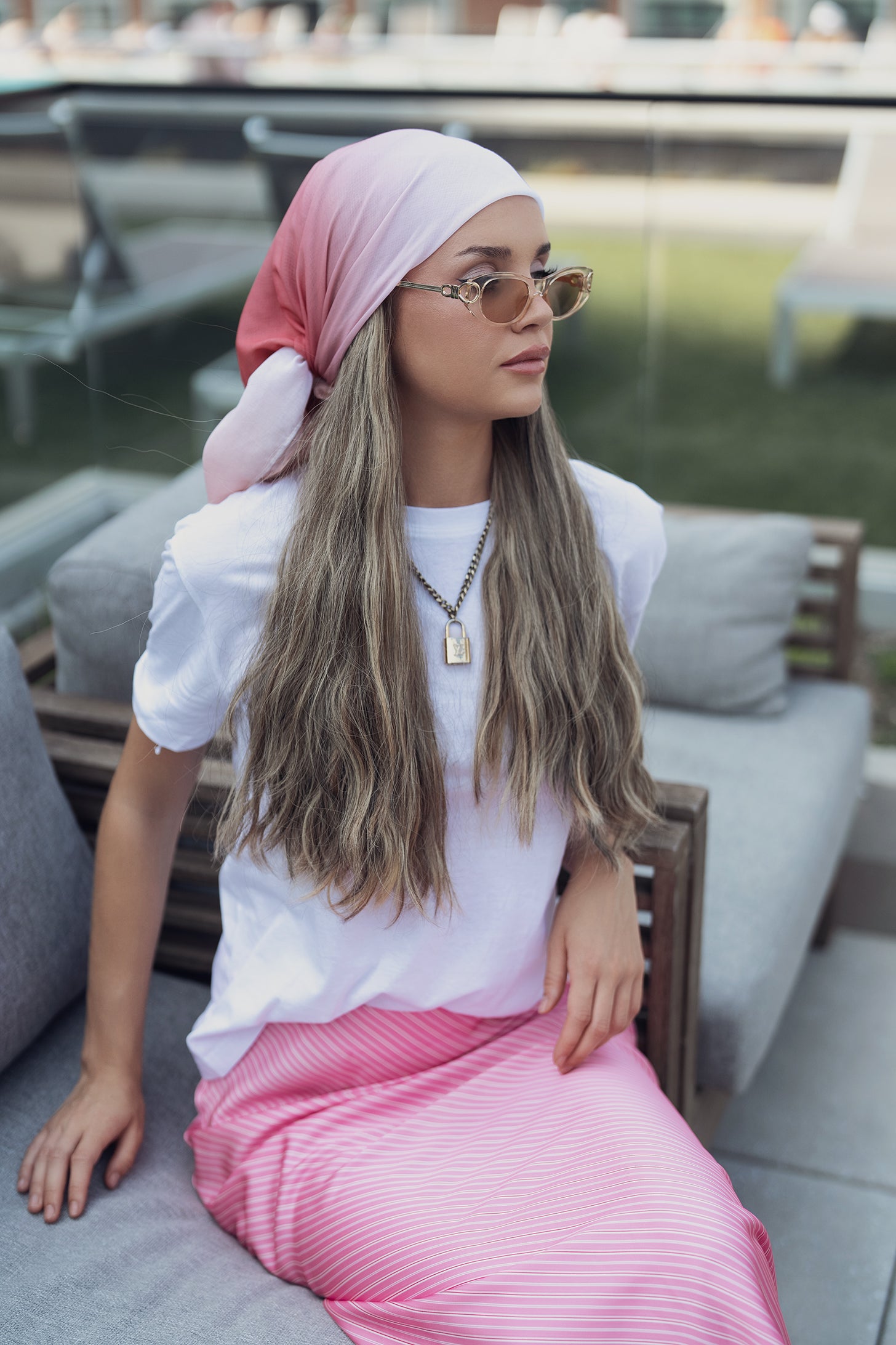 Pale pink headscarf styled with gold necklace and white shirt