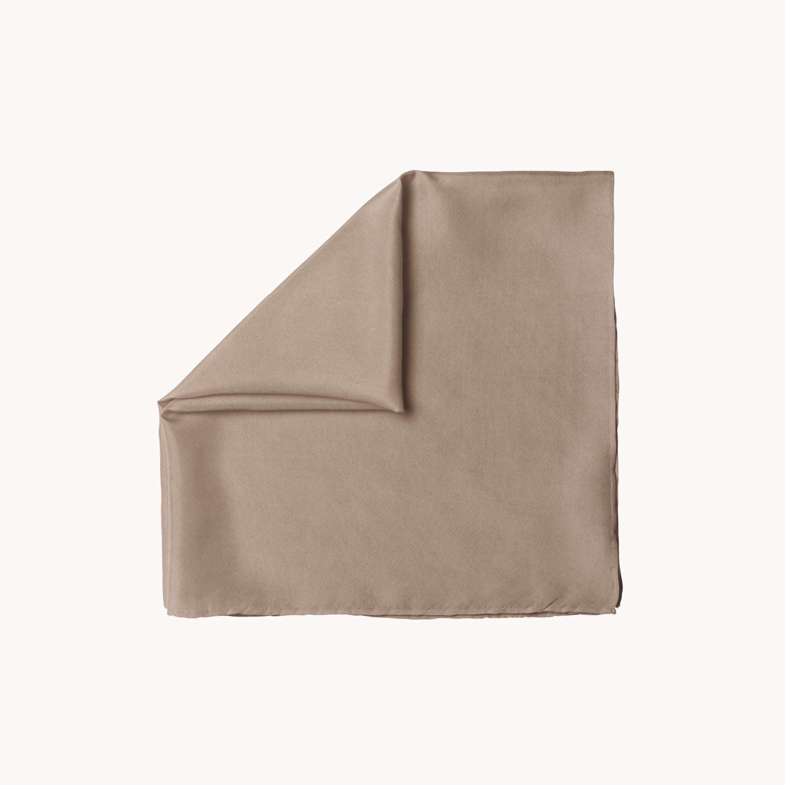 Folded square silk headscarf in a neutral bare beauty taupe shade, featuring a silky-smooth texture with a soft matte glow, set against a clean white background.
