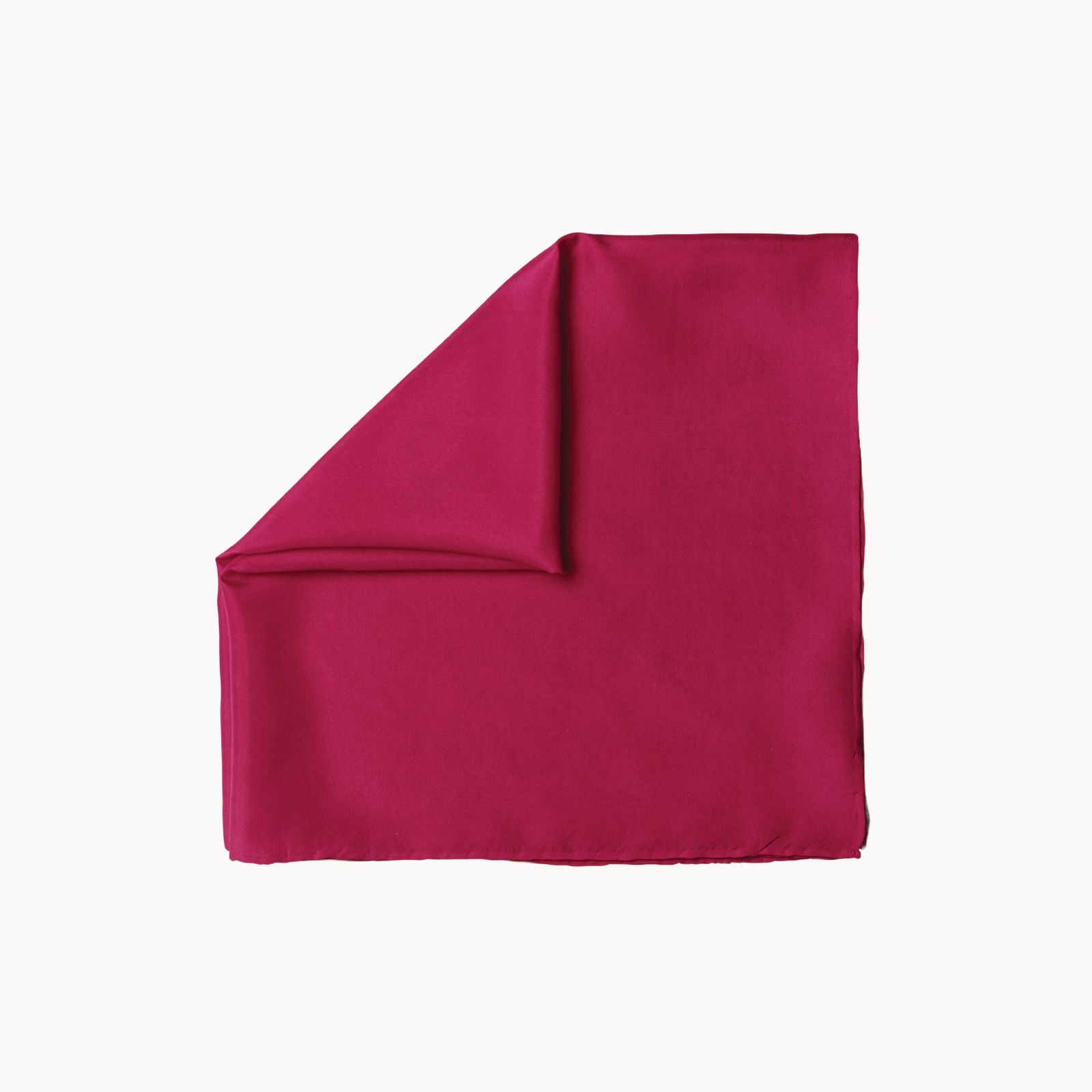 Folded square hibiscus pink silk headscarf on a white background.